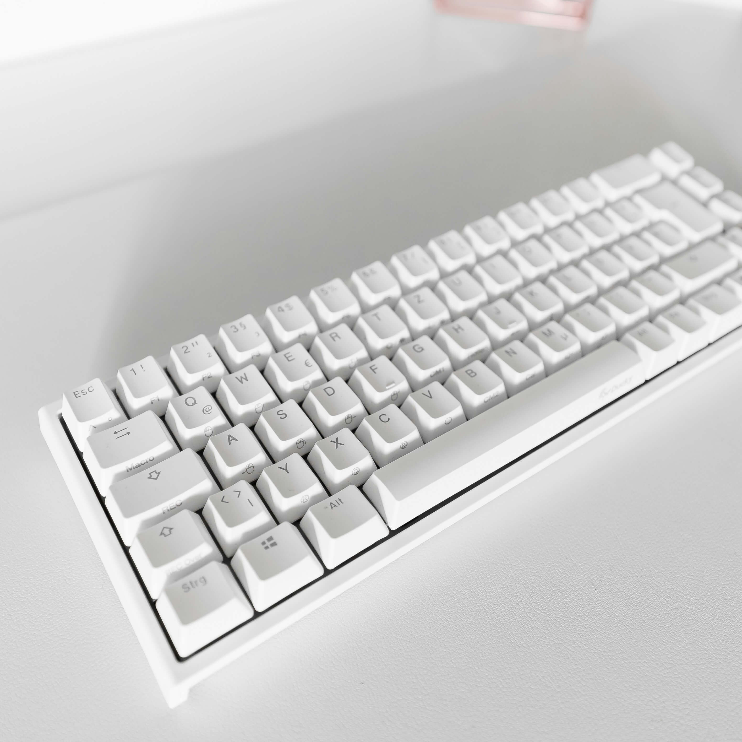 A white keyboard on a white surface